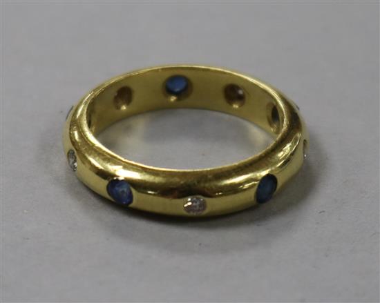 An 18ct gold, gypsy set sapphire and diamond eternity ring, size M.